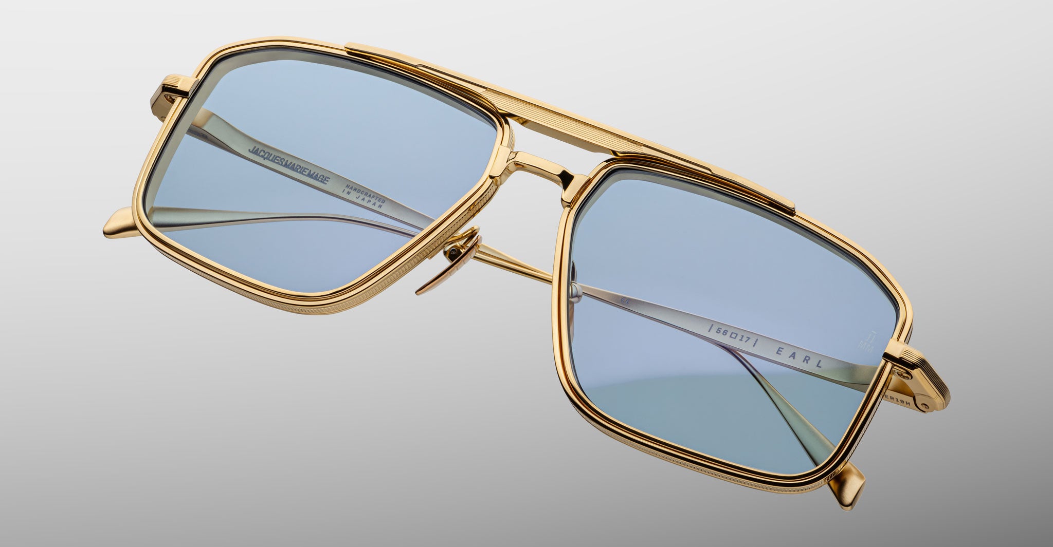 Jacques Marie Mage Earl gold aviator sunglasses with blue-tinted lenses shown from the front.