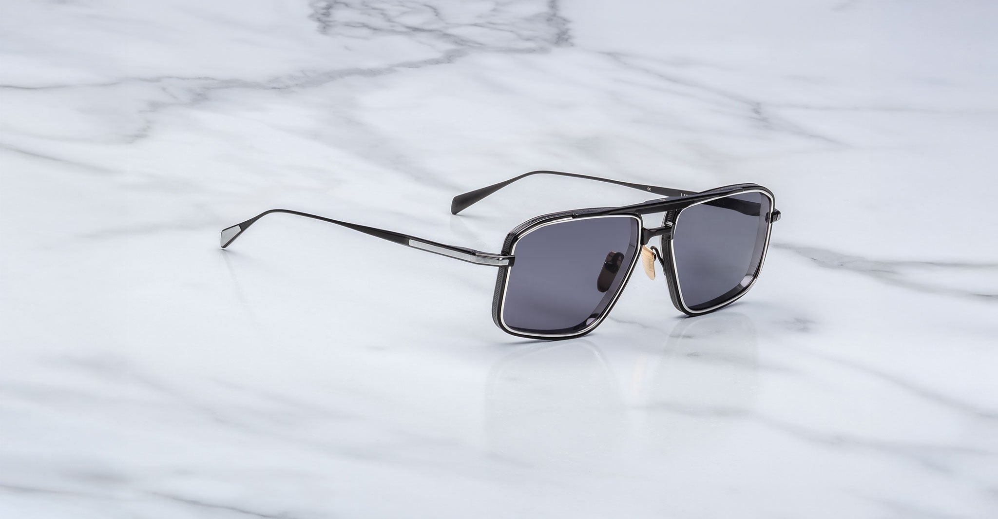 Jacques Marie Mage Earl black rectangular sunglasses with dark lenses, top view.