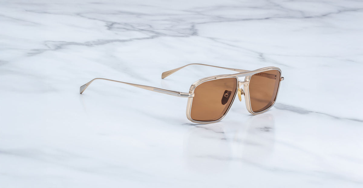 Jacques Marie Mage Earl gold aviator sunglasses with brown lenses, shown from above.