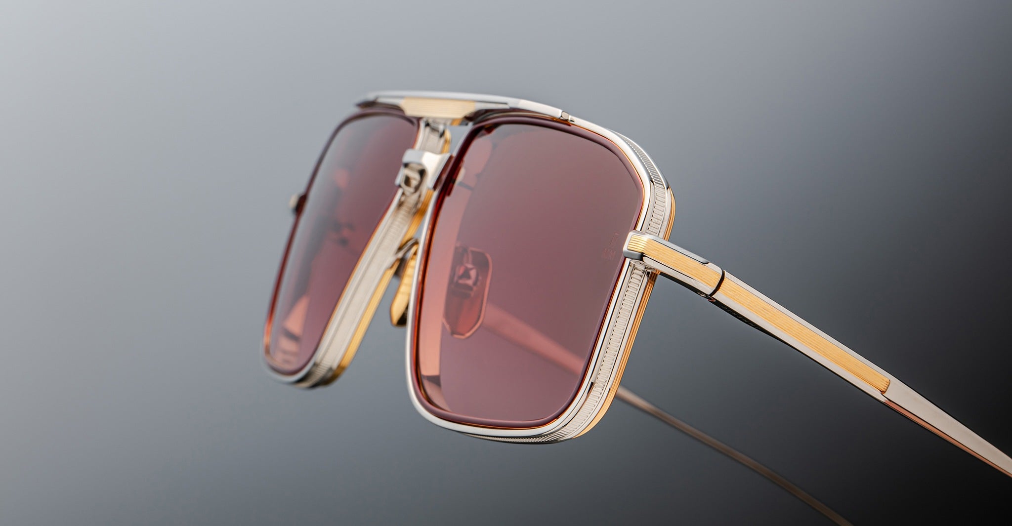 Jacques Marie Mage Earl gold sunglasses, close-up view, featuring rectangular pink lenses.
