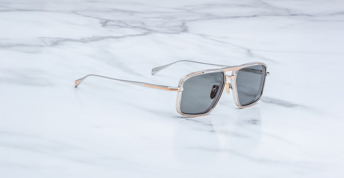 Jacques Marie Mage Earl aviator sunglasses with silver frames and dark lenses, top view.