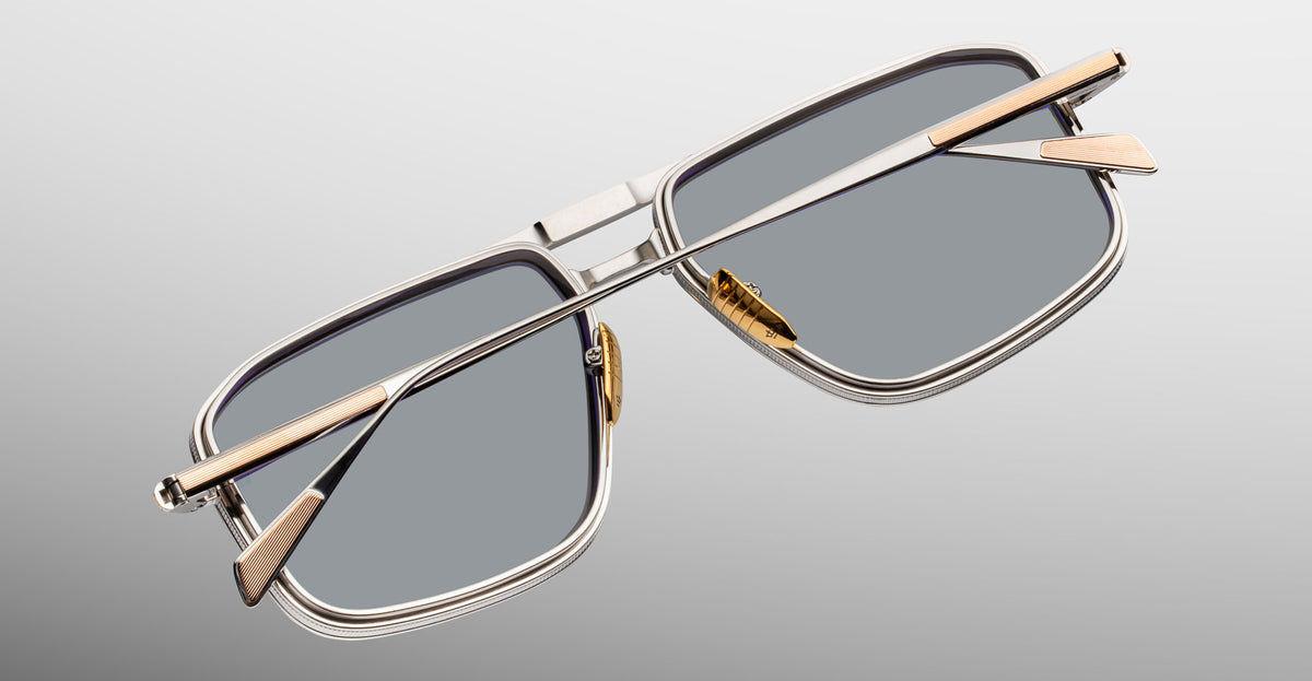 Jacques Marie Mage Earl rectangular silver sunglasses with gold temples, shown from the front.