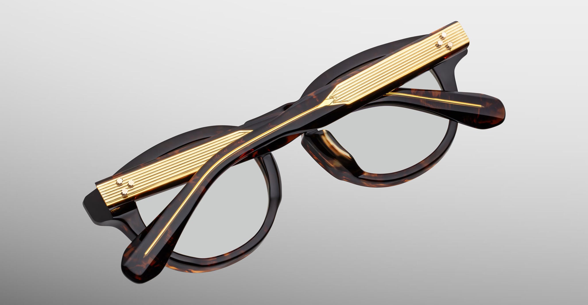 Jacques Marie Mage Eiko tortoiseshell eyeglasses with gold temples, shown folded, side view.