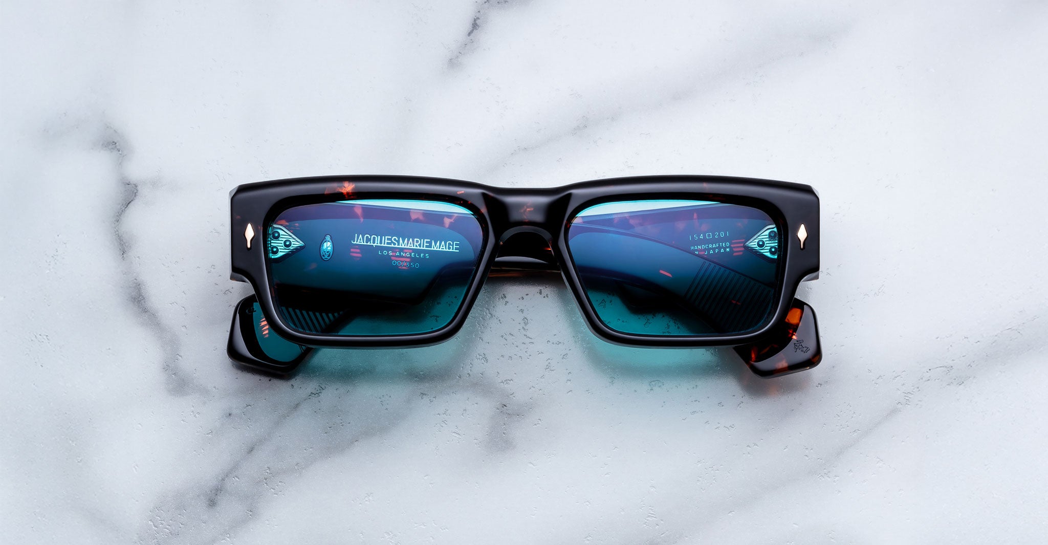 Jacques Marie Mage Engel black rectangular sunglasses with blue mirrored lenses, front angle.