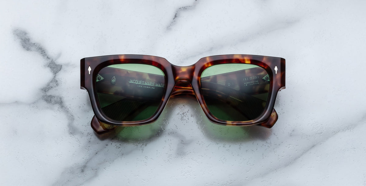 Jacques Marie Mage Enzo cat-eye sunglasses with green lenses, top view.