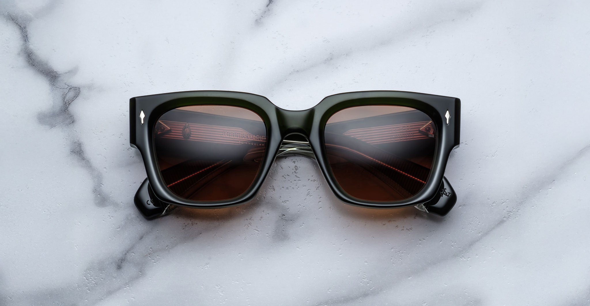 Jacques Marie Mage Enzo black square sunglasses with UV-protection dark lenses, viewed from above.