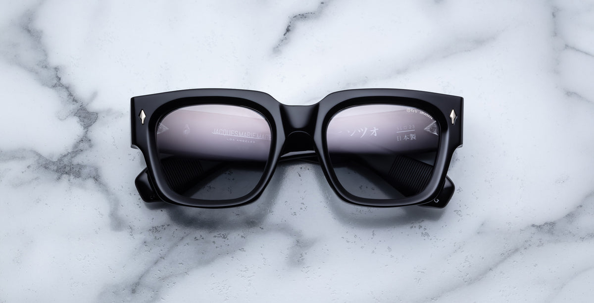 Jacques Marie Mage Enzo black rectangular sunglasses with reflective lenses, top view.