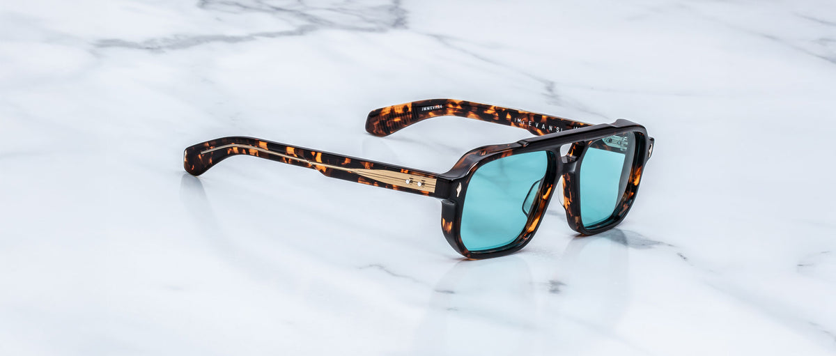 Jacques Marie Mage Evans sunglasses with blue lenses, top view, product on display.