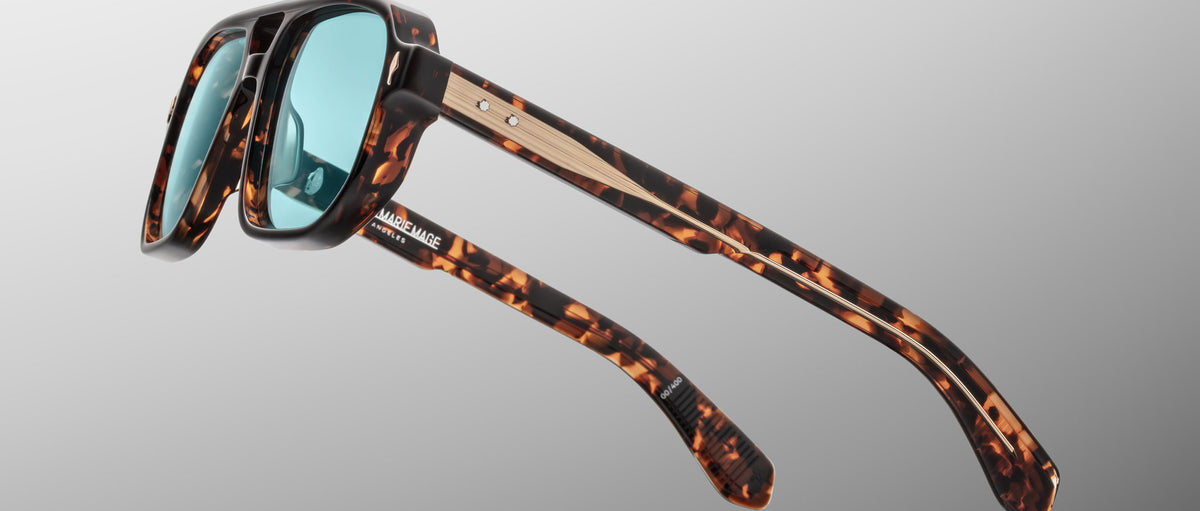 Jacques Marie Mage Evans tortoiseshell sunglasses with blue lenses and wood accents, shown from the front.