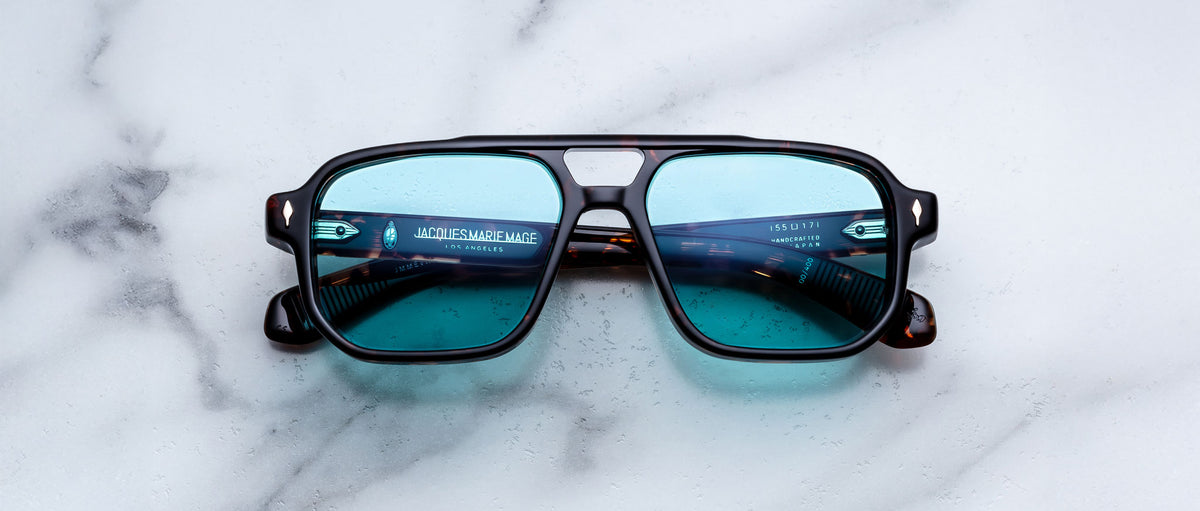 Jacques Marie Mage Evans sunglasses with blue lenses and black frames, shown from the front.