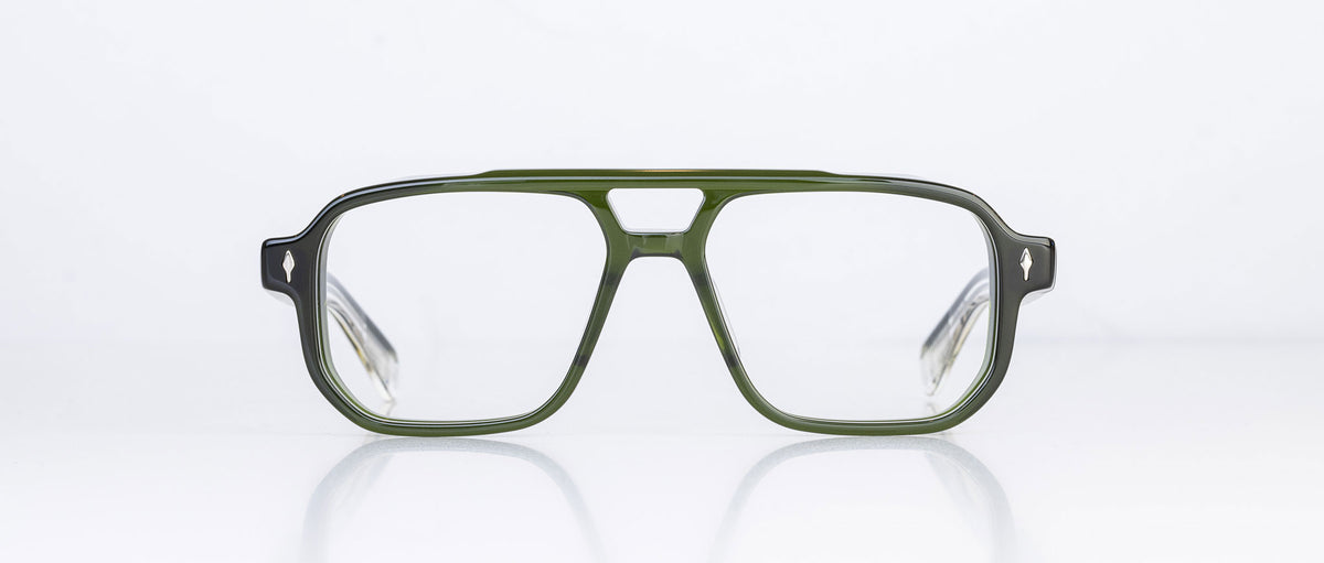 The Jacques Marie Mage Evans by Jacques Marie Mage is a pair of green rectangular eyeglasses featuring a thick, oversized acetate frame, shown from the front against a plain white background.