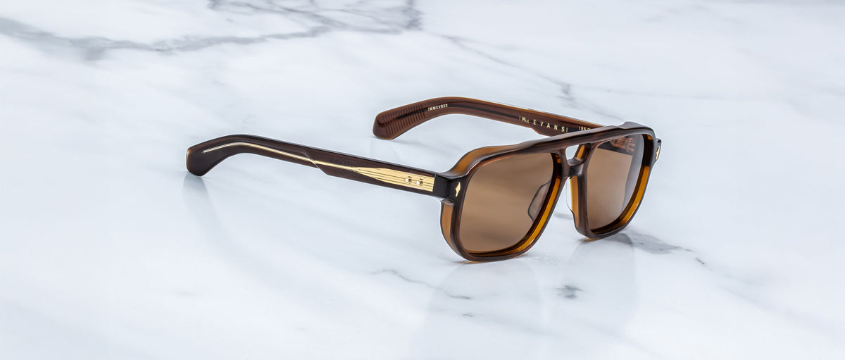 Jacques Marie Mage Evans sunglasses with brown polarized lenses and gold accents shown from above.