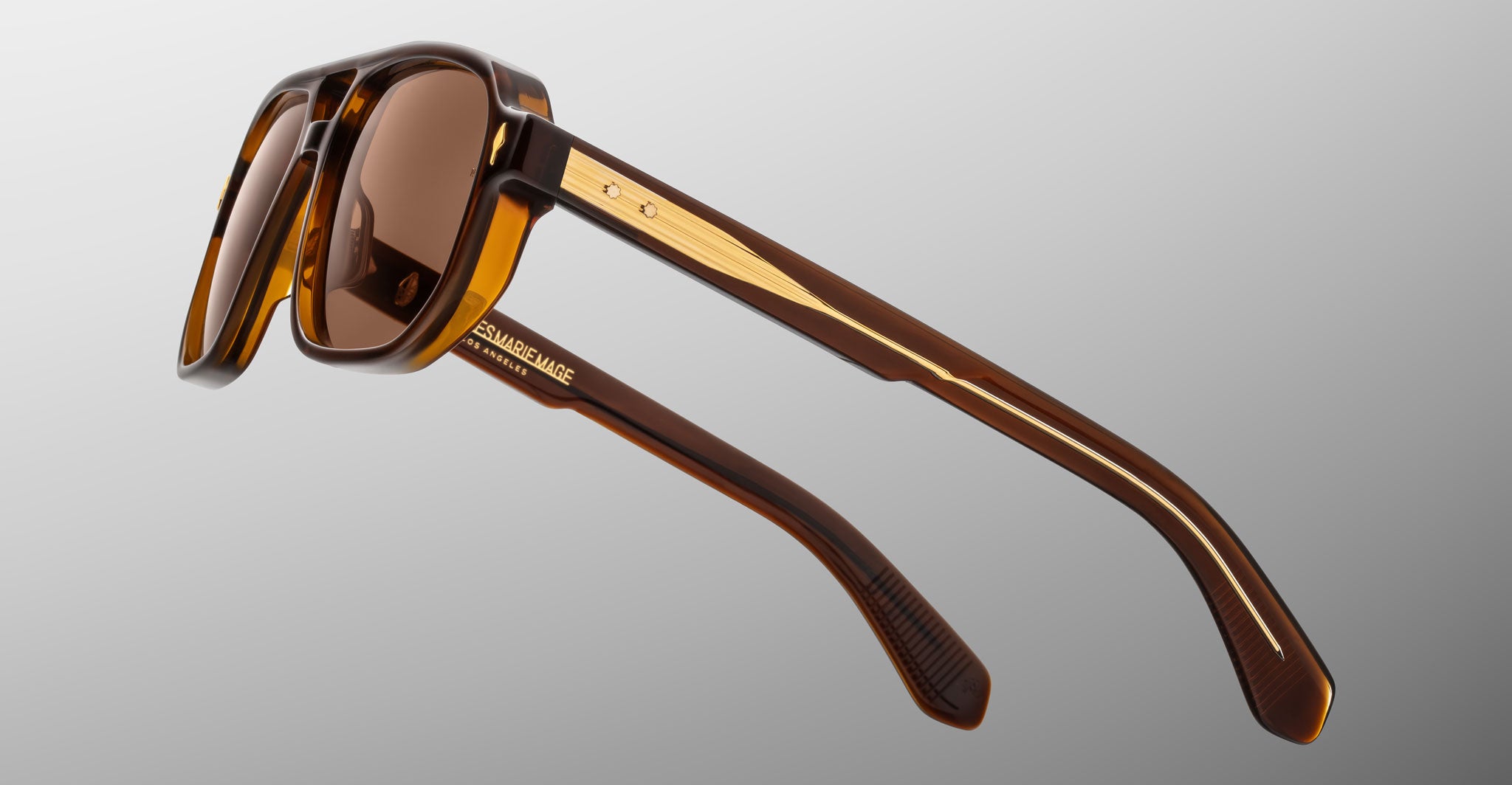 Jacques Marie Mage Evans sunglasses, angular brown frames with gold accents and tinted lenses, front view.