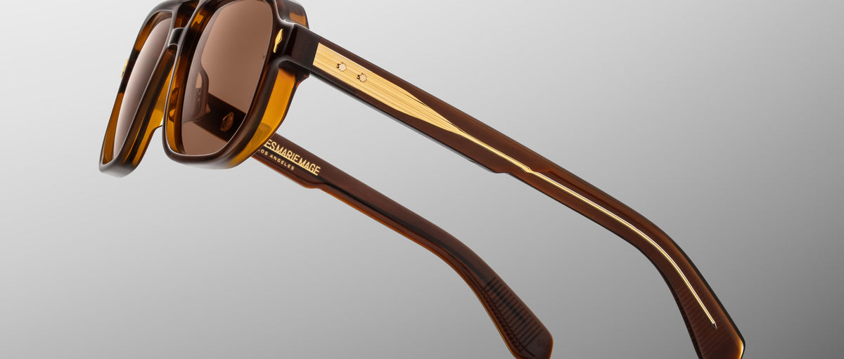 Jacques Marie Mage Evans sunglasses, angular brown frames with gold accents and tinted lenses, front view.
