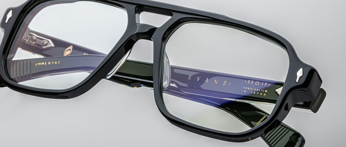 Close-up of Jacques Marie Mage Evans handcrafted optical glasses featuring rectangular lenses and detailed design, with engraved branding on the inside of the oversized acetate temples.