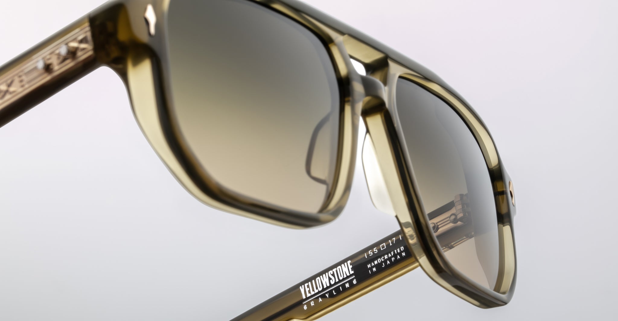 Close-up of Jacques Marie Mage Evans sunglasses featuring a thick, oversized acetate frame with brown-tinted lenses. The distinctive branding and model details on the arm highlight Jacques Marie Mage's signature handcrafted style.