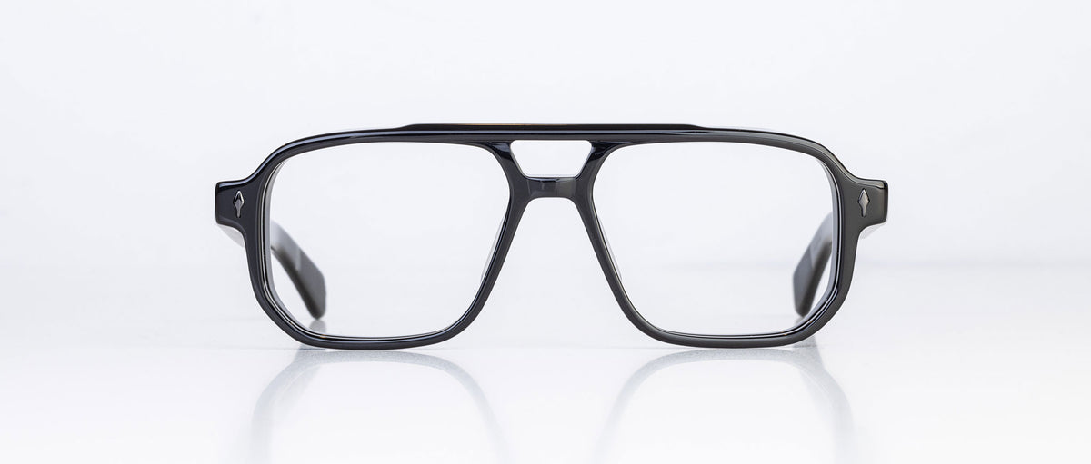 The Jacques Marie Mage Evans are black rectangular optical glasses with a keyhole bridge and oversized acetate frame, showcased on a white background.