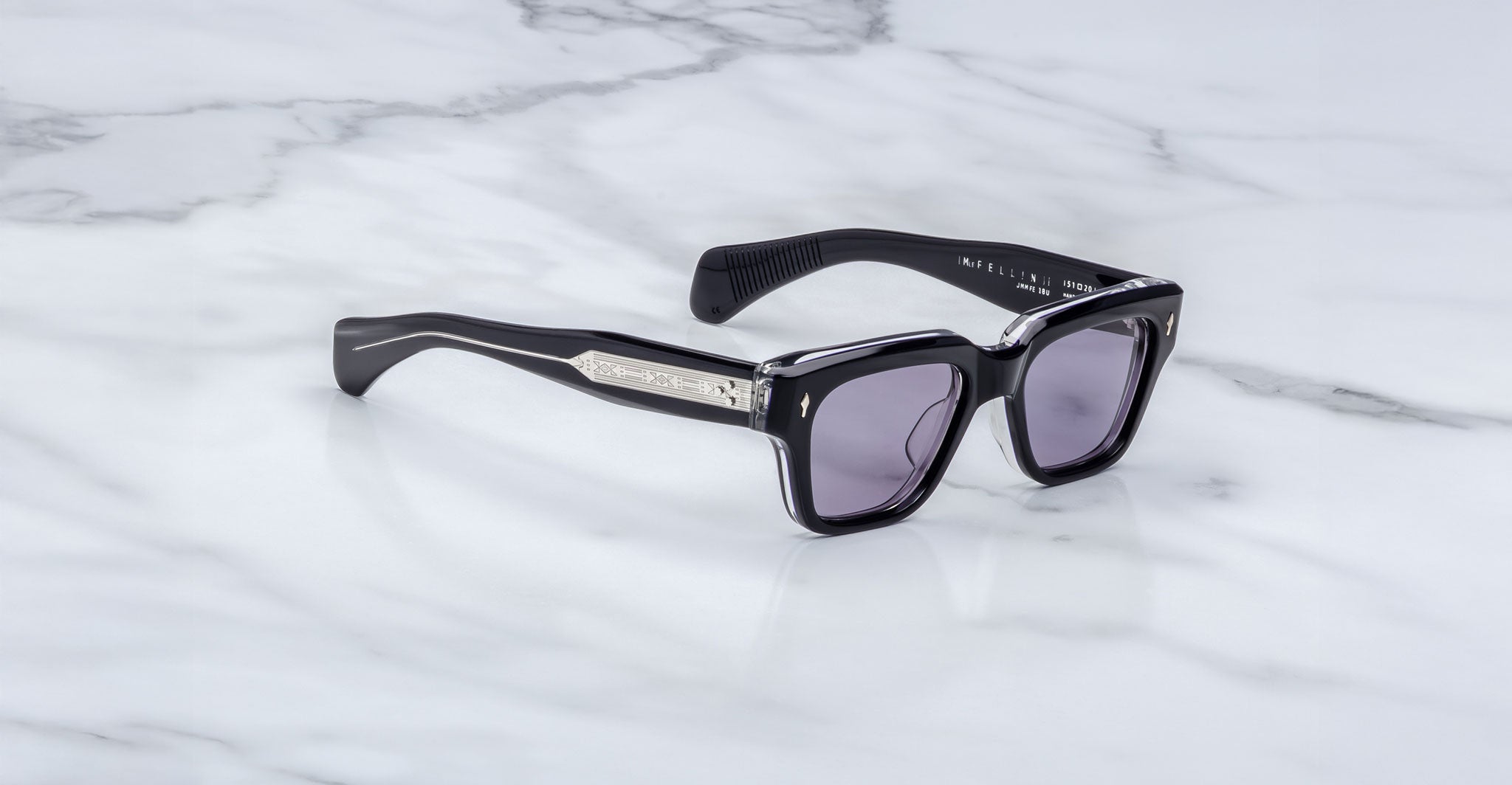 Jacques Marie Mage Fellini black rectangular sunglasses with silver-accented arms, shown from above.