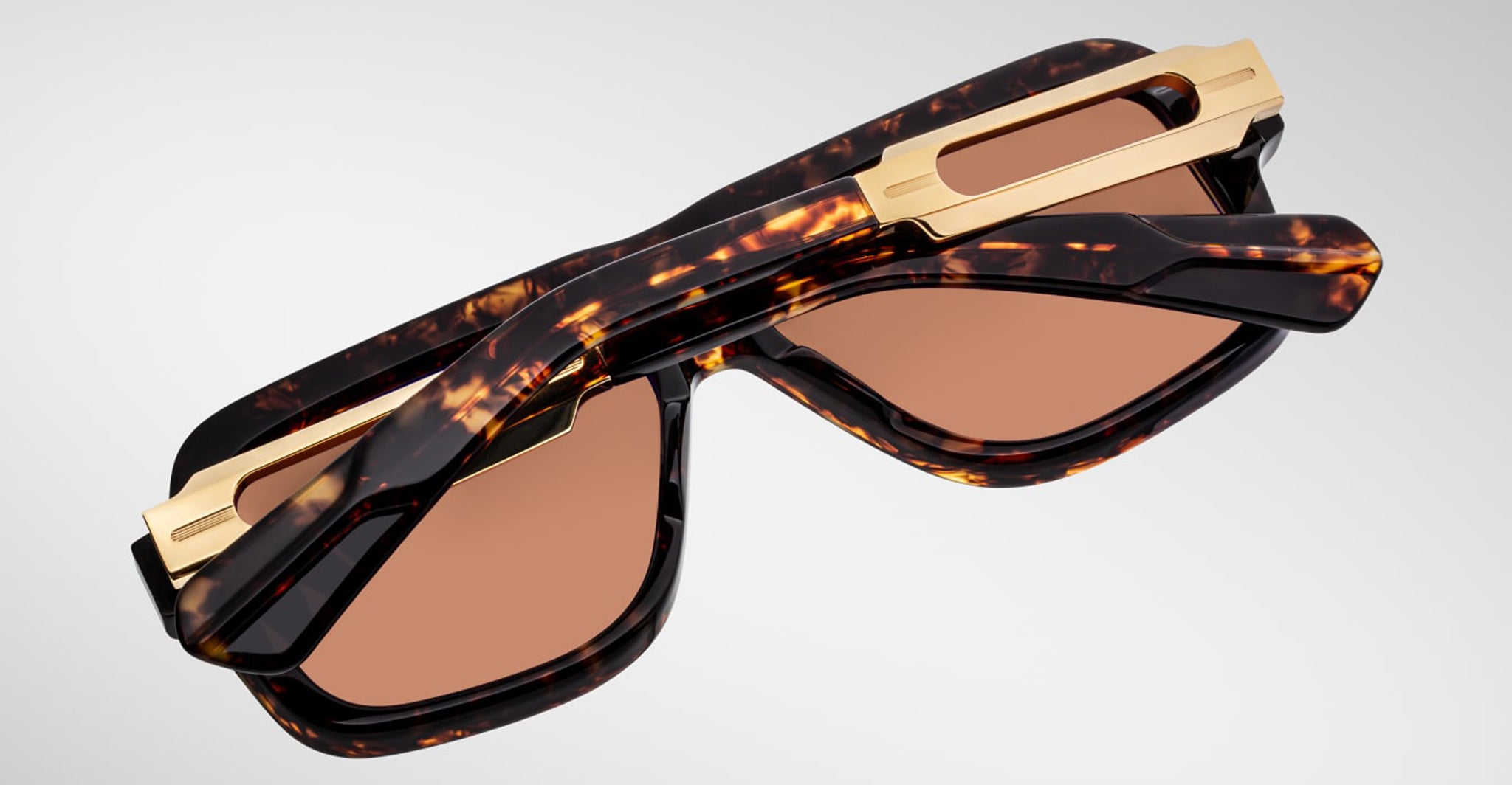 Jacques Marie Mage Fugue tortoiseshell sunglasses with gold accents and brown UV lenses, front angle view.