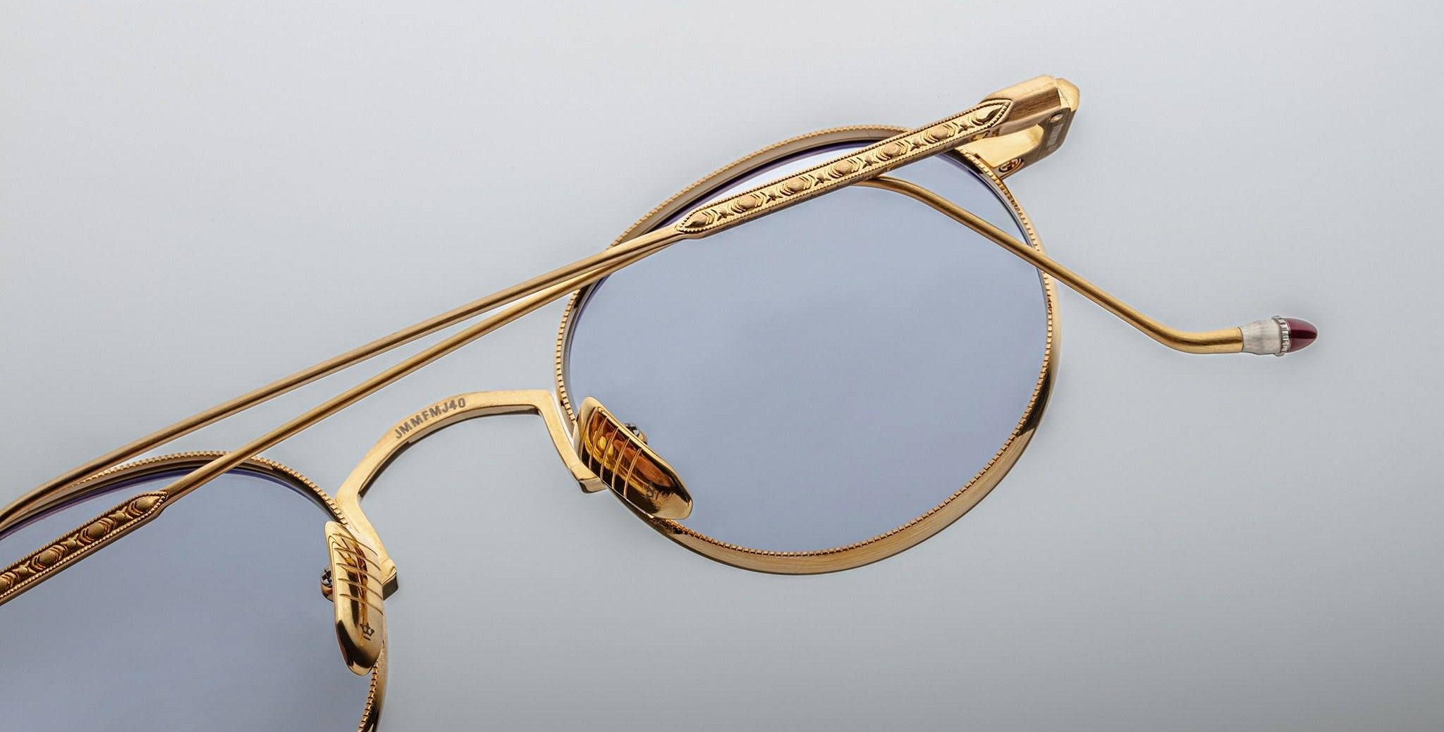 Close-up of Jacques Marie Mage Full Metal Jacket gold-framed eyeglasses