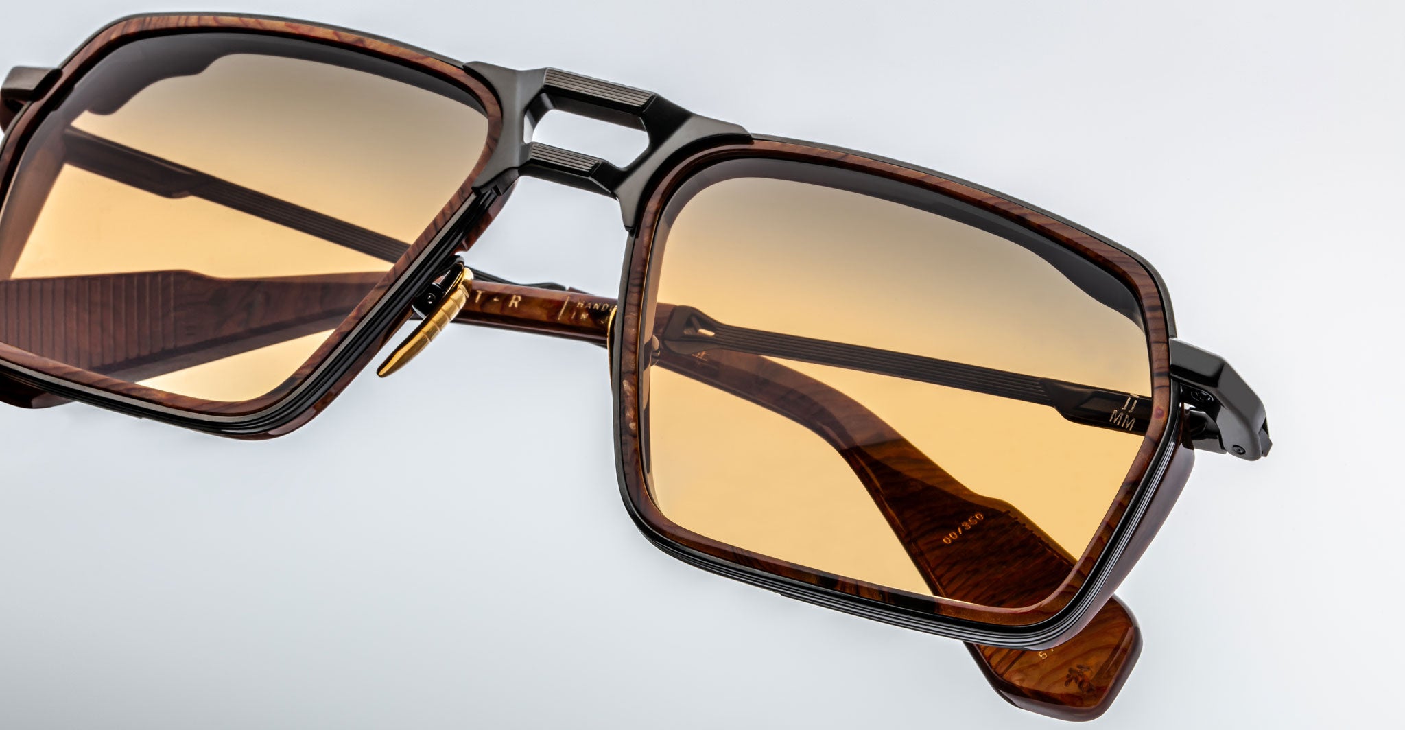 Close-up of Jacques Marie Mage GT-R brown rectangular sunglasses with amber-tinted lenses, double bridge, and brown tortoiseshell arms, set against a plain light background.
