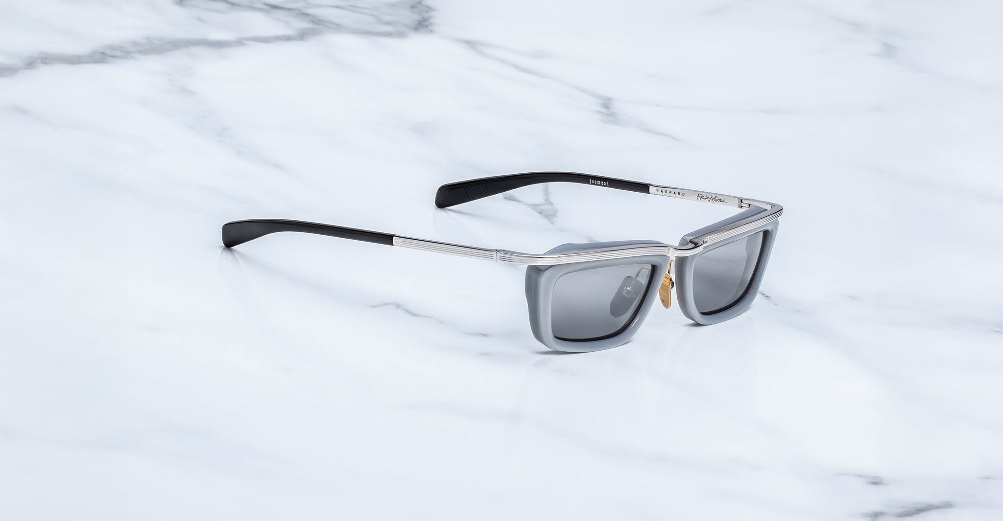 Jacques Marie Mage Gaspard sunglasses in black and silver with gray UV lenses, shown from above.