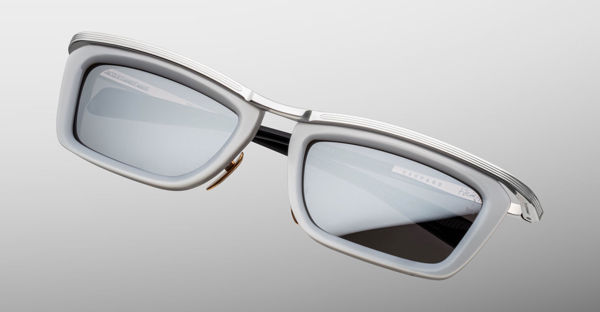 Jacques Marie Mage Gaspard rectangular silver-gray sunglasses with black arms, front view.