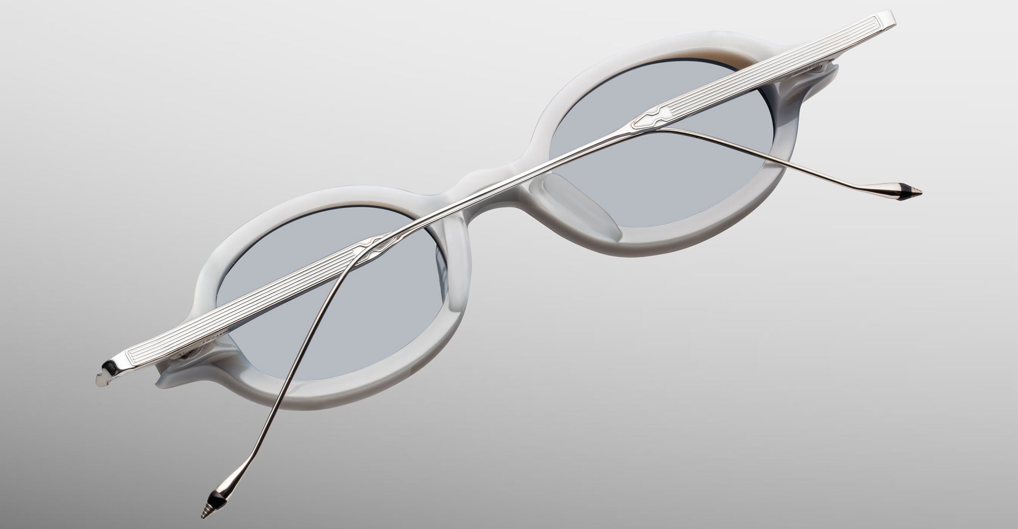 Jacques Marie Mage Balthazar white oval sunglasses with silver arms, back view.