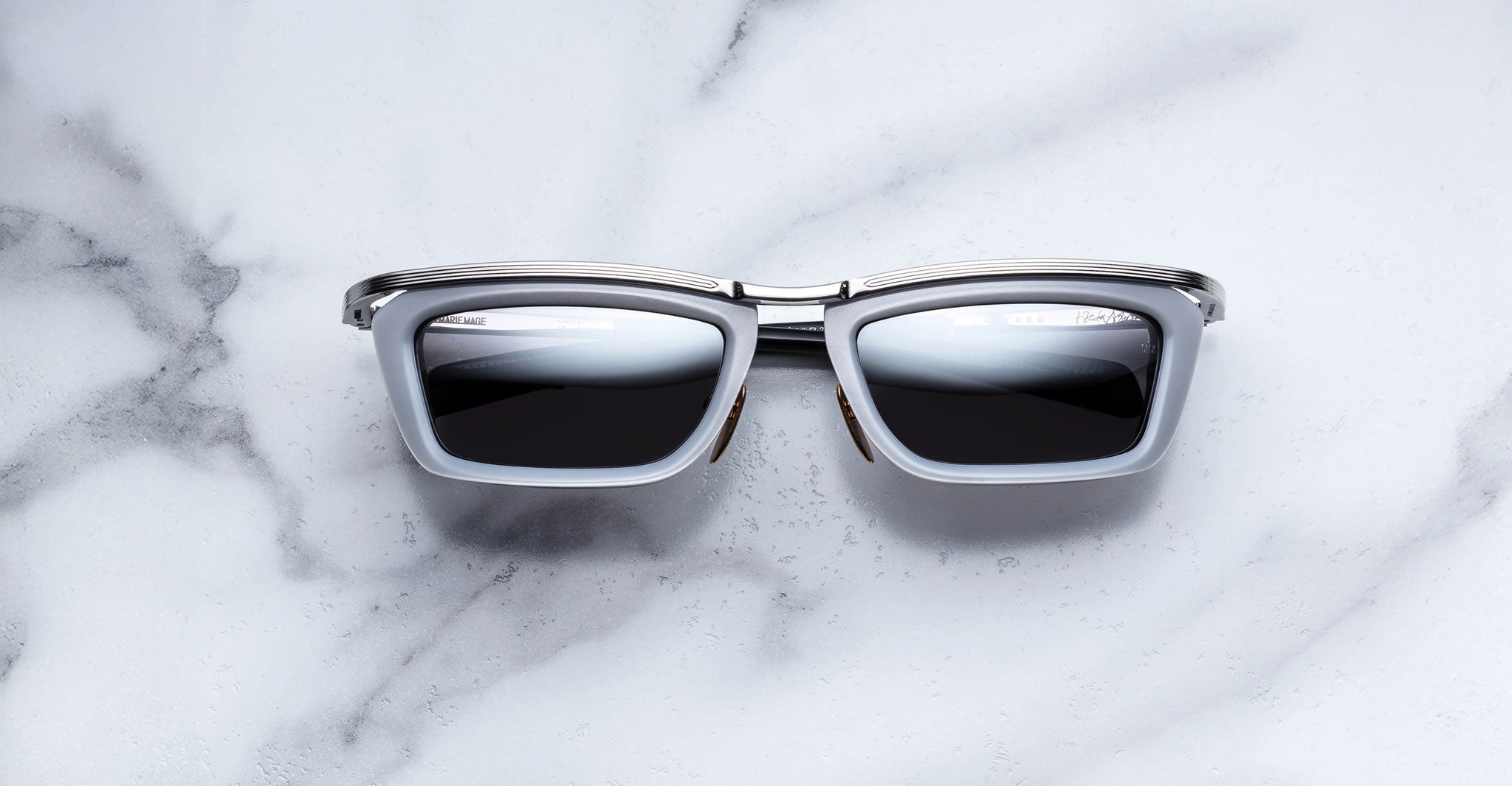 Jacques Marie Mage Gaspard silver and black square sunglasses, top view showing frame shape and colors.