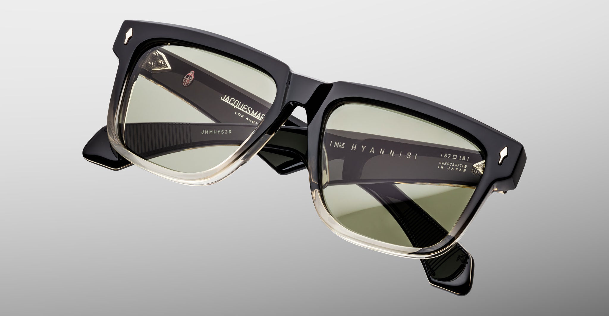 Jacques Marie Mage Hyannis in Black Fade rectangular sunglasses, black frame with green-tinted lenses, front view.