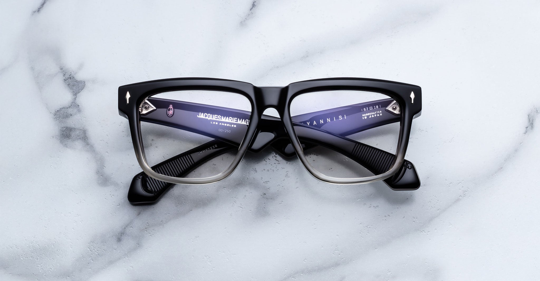 Jacques Marie Mage Hyannis in Black Fade black and gray square eyeglasses frame, front view, shown on flat surface.