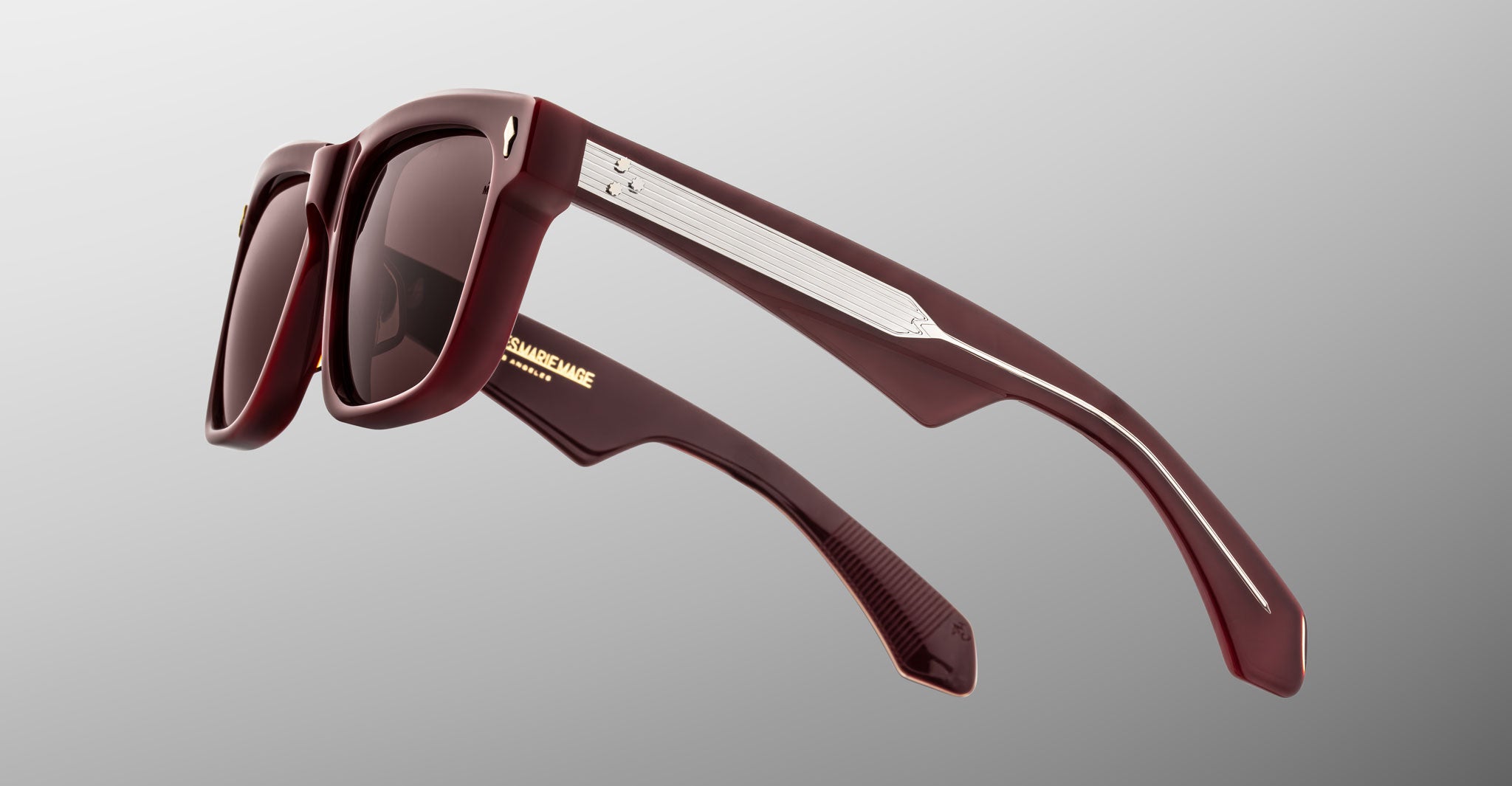 Jacques Marie Mage Hyannis in Bordeaux Empire dark red rectangular sunglasses with thick frames, silver accents, and gold branding on the inner arm, side view.