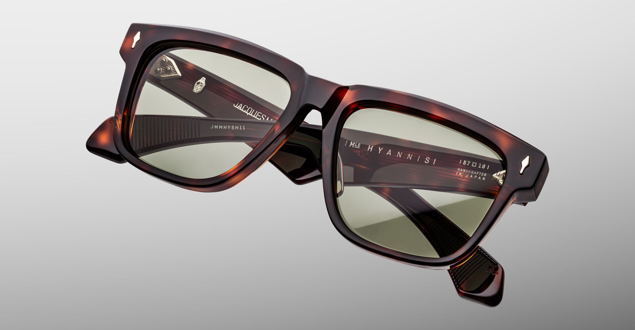 Jacques Marie Mage Hyannis in Tenace square tortoiseshell sunglasses, close-up view, with green tinted lenses and Prada branding on the arms.