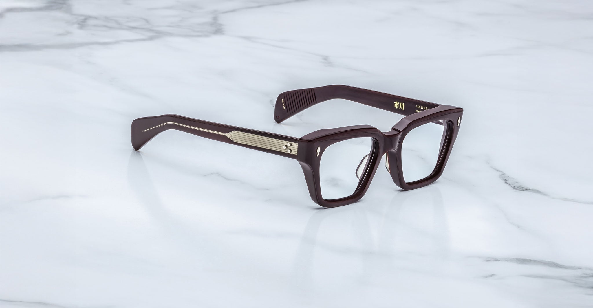 Jacques Marie Mage Ichikawa brown rectangular eyeglasses with thick frames and gold accents, shown from the front.