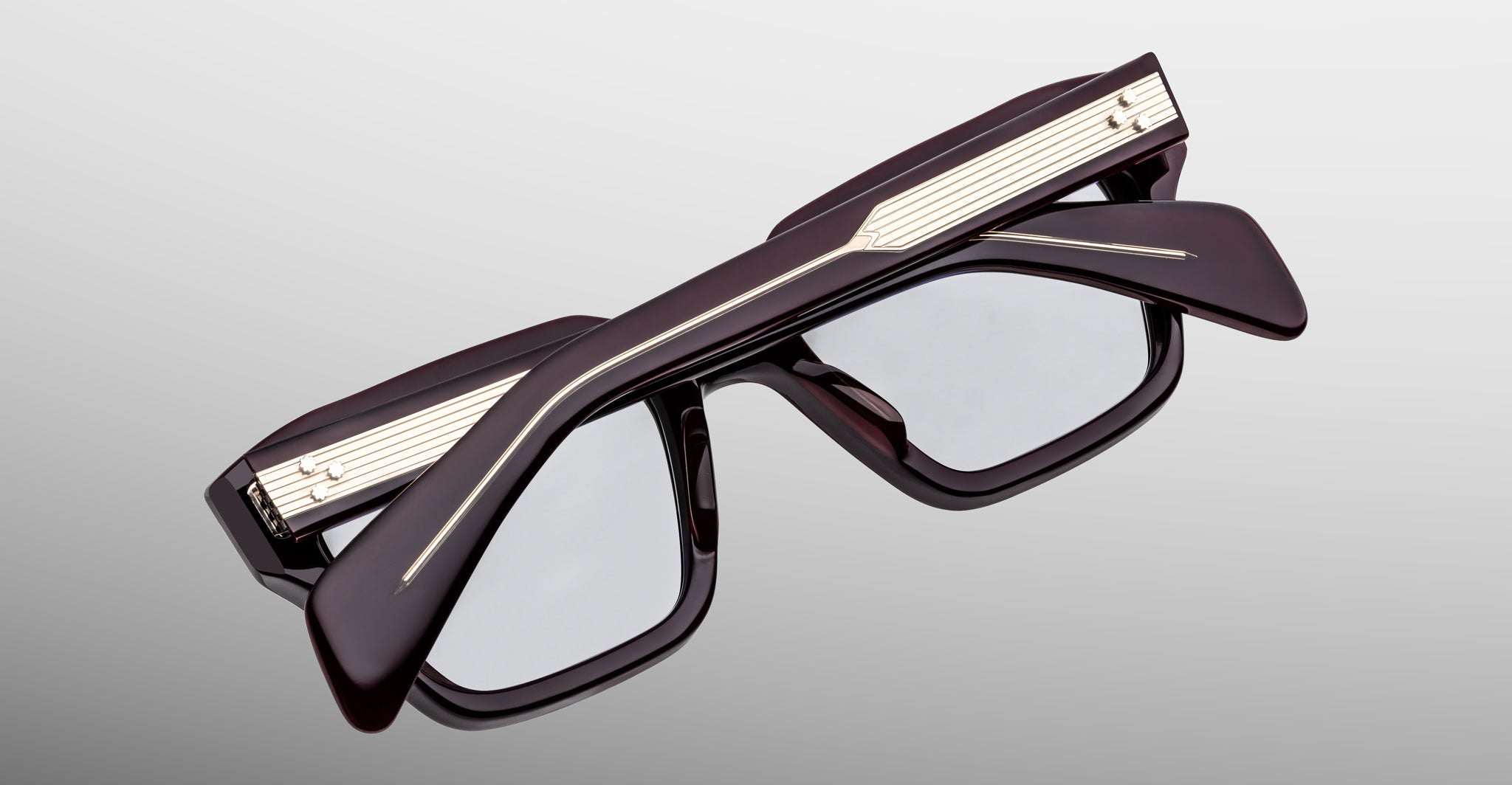 Jacques Marie Mage Ichikawa rectangular eyeglasses with dark thick frames and gold accents, viewed from the front.