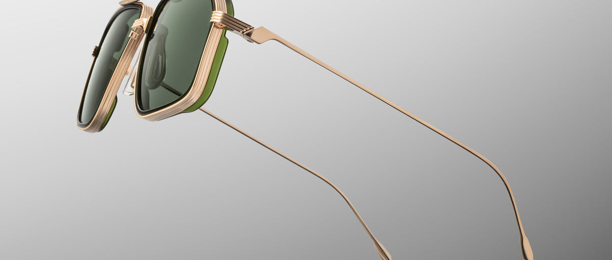 Jacques Marie Mage Jagger gold sunglasses with green lenses and thin arms, front angled view.