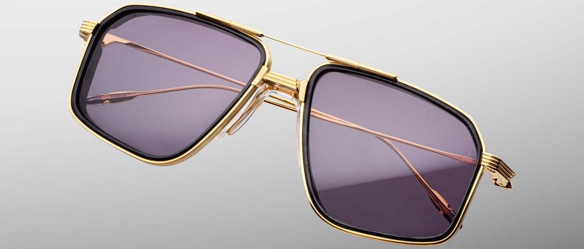 Jacques Marie Mage Jagger square sunglasses with gold rims, dark lenses, and thin metal arms shown from the front angle.