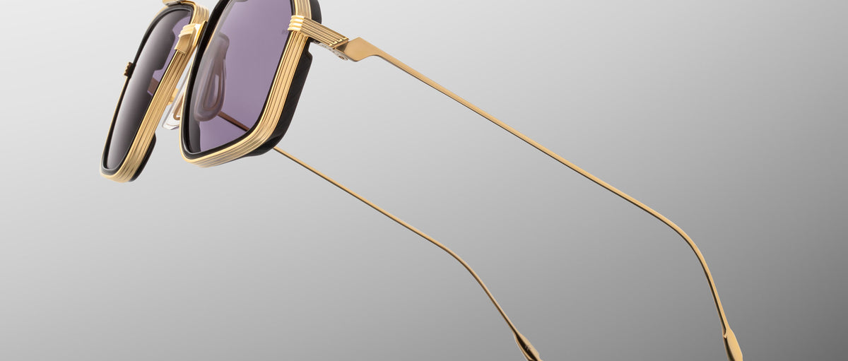 Jacques Marie Mage Jagger sunglasses, gold frames, purple lenses, angular shape, ultra-thin metal arms; front view.