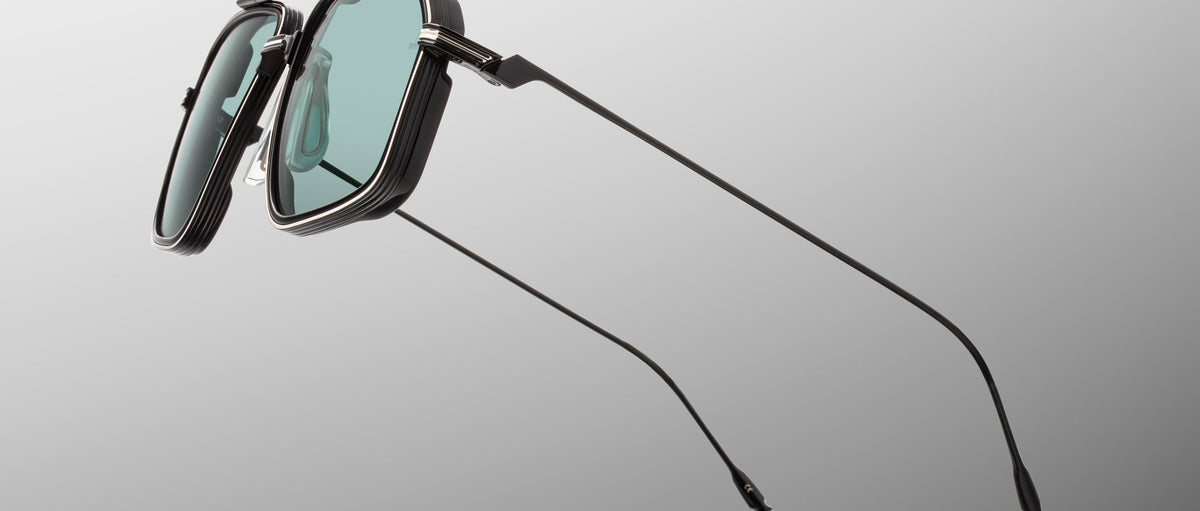 Jacques Marie Mage Jagger black sunglasses with green rectangular lenses and slim temples, front view.