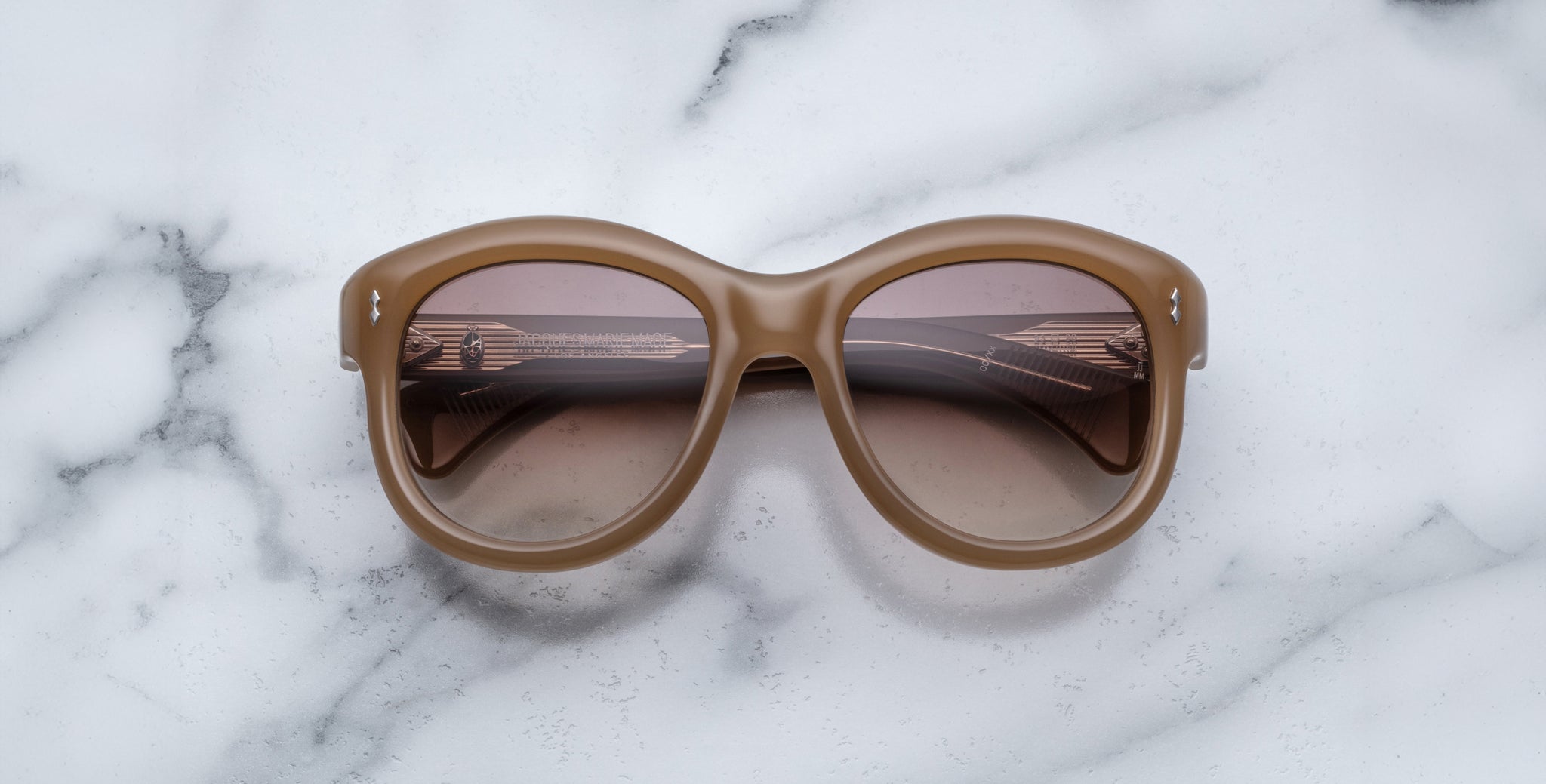 Jacques Marie Mage Jennie round brown sunglasses with tinted lenses, top view.