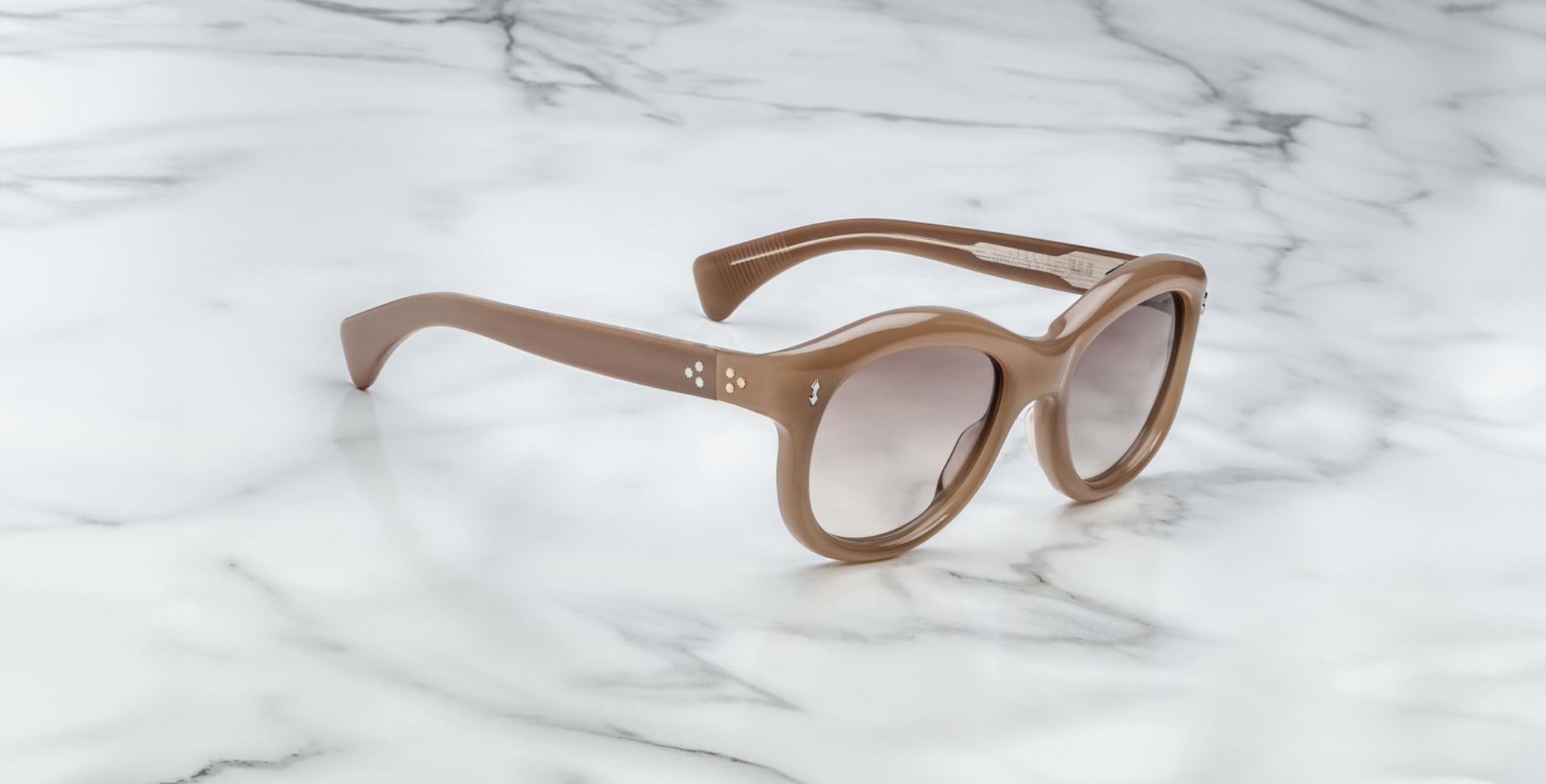 Jacques Marie Mage Jennie round beige sunglasses with UV protection shown from above.