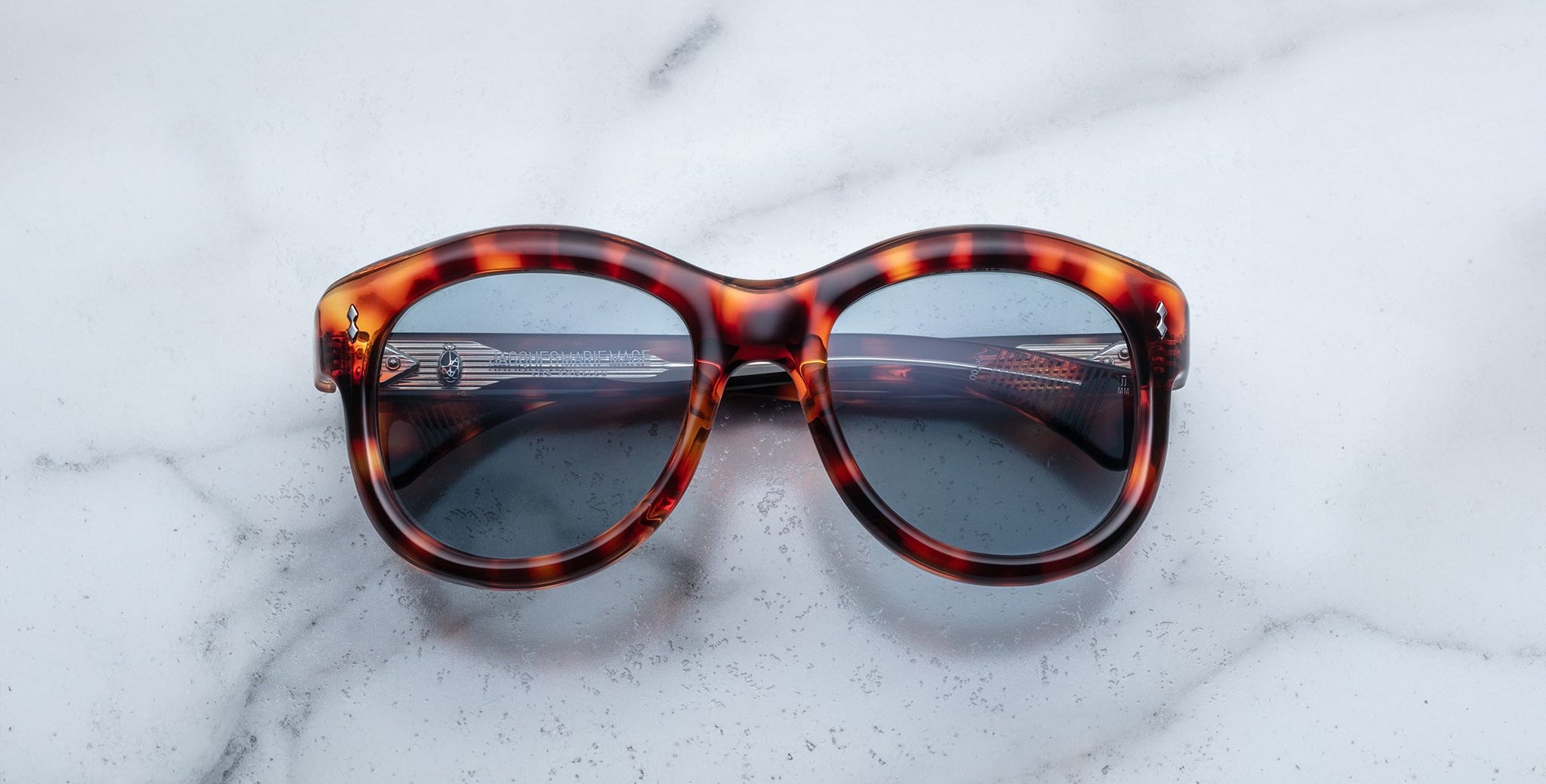 Jacques Marie Mage Jennie sunglasses featuring dark UV lenses, shown from above.