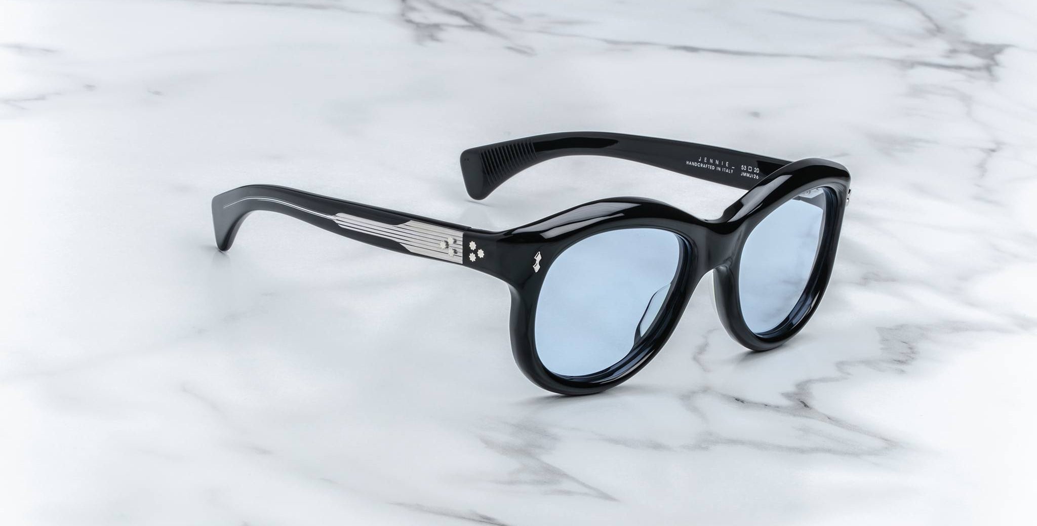 Jacques Marie Mage Jennie sunglasses with blue-tinted lenses and silver accents, top view.