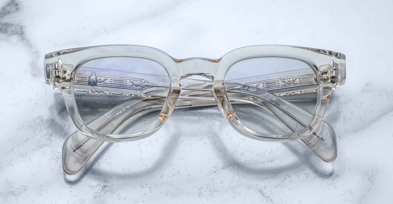 Jacques Marie Mage Julien in Beige rectangular optical frame in translucent beige acetate with a soft, neutral tone, featuring a keyhole bridge, signature arrowhead front pins, and exposed metal core detailing within the temples, shown with clear lenses.