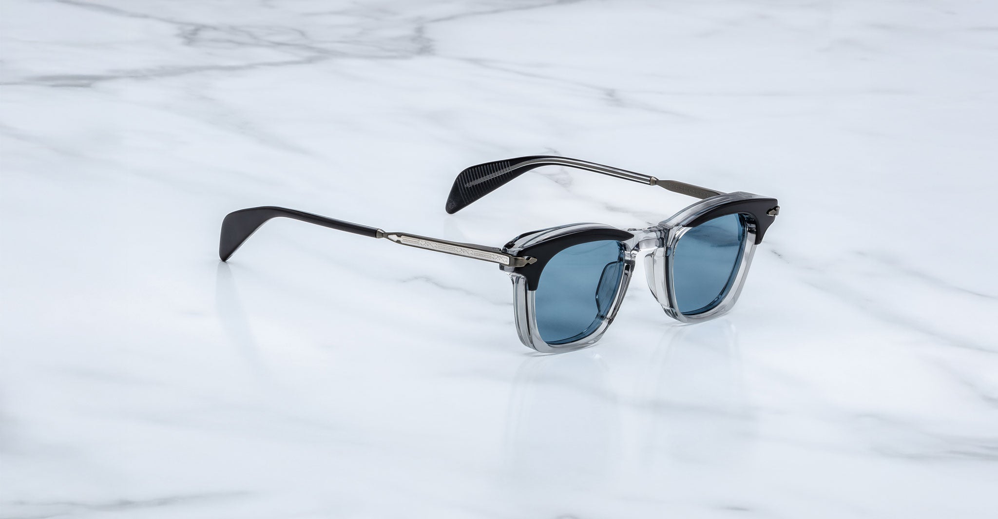 Jacques Marie Mage Kennedy sunglasses with blue lenses and black-clear frames, front view.