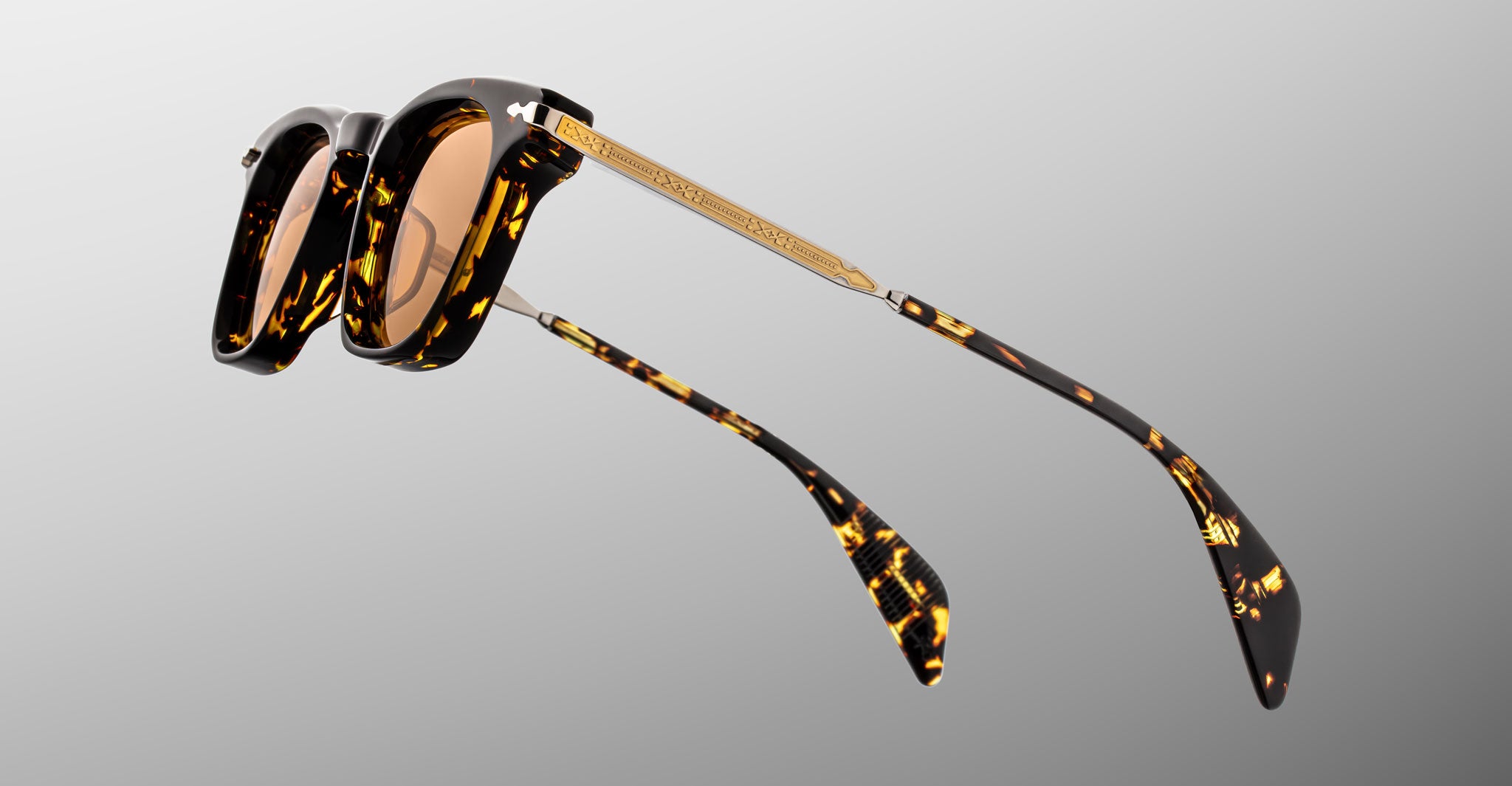 Jacques Marie Mage Kennedy sunglasses feature a tortoiseshell frame, gold accents, and UV-brown lenses. Front view shown.