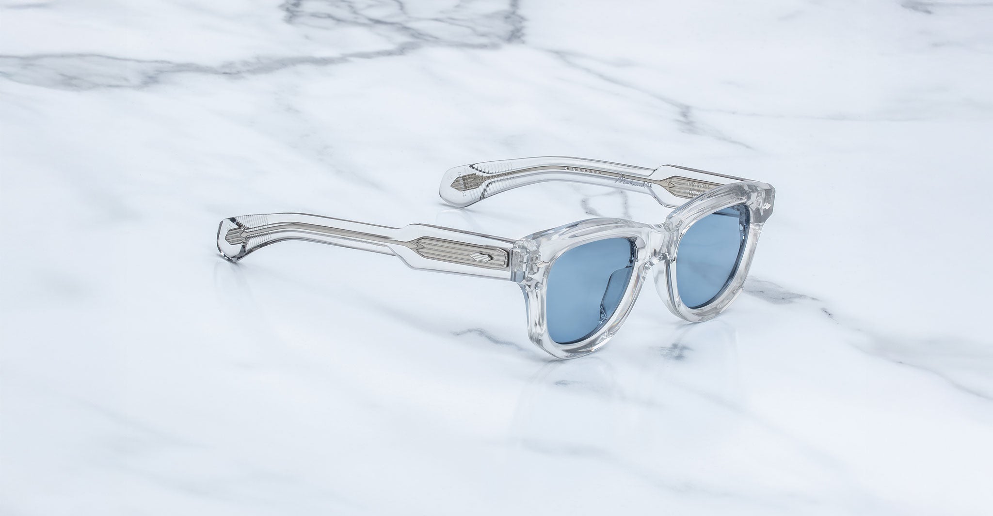 Jacques Marie Mage Kinshasa clear sunglasses with blue mirrored lenses, top view.