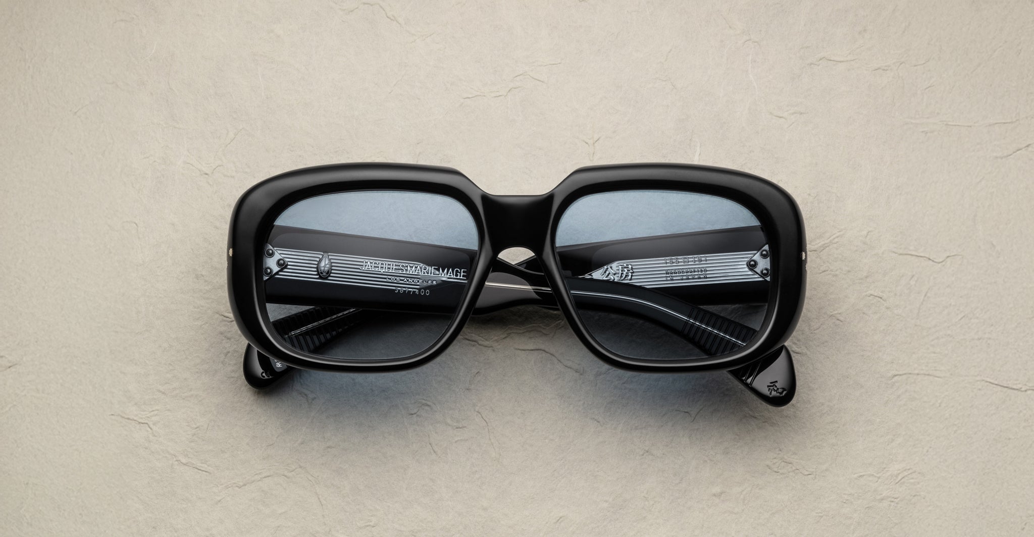Jacques Marie Mage Kobo black rectangular eyeglasses with thick frames, viewed from above.