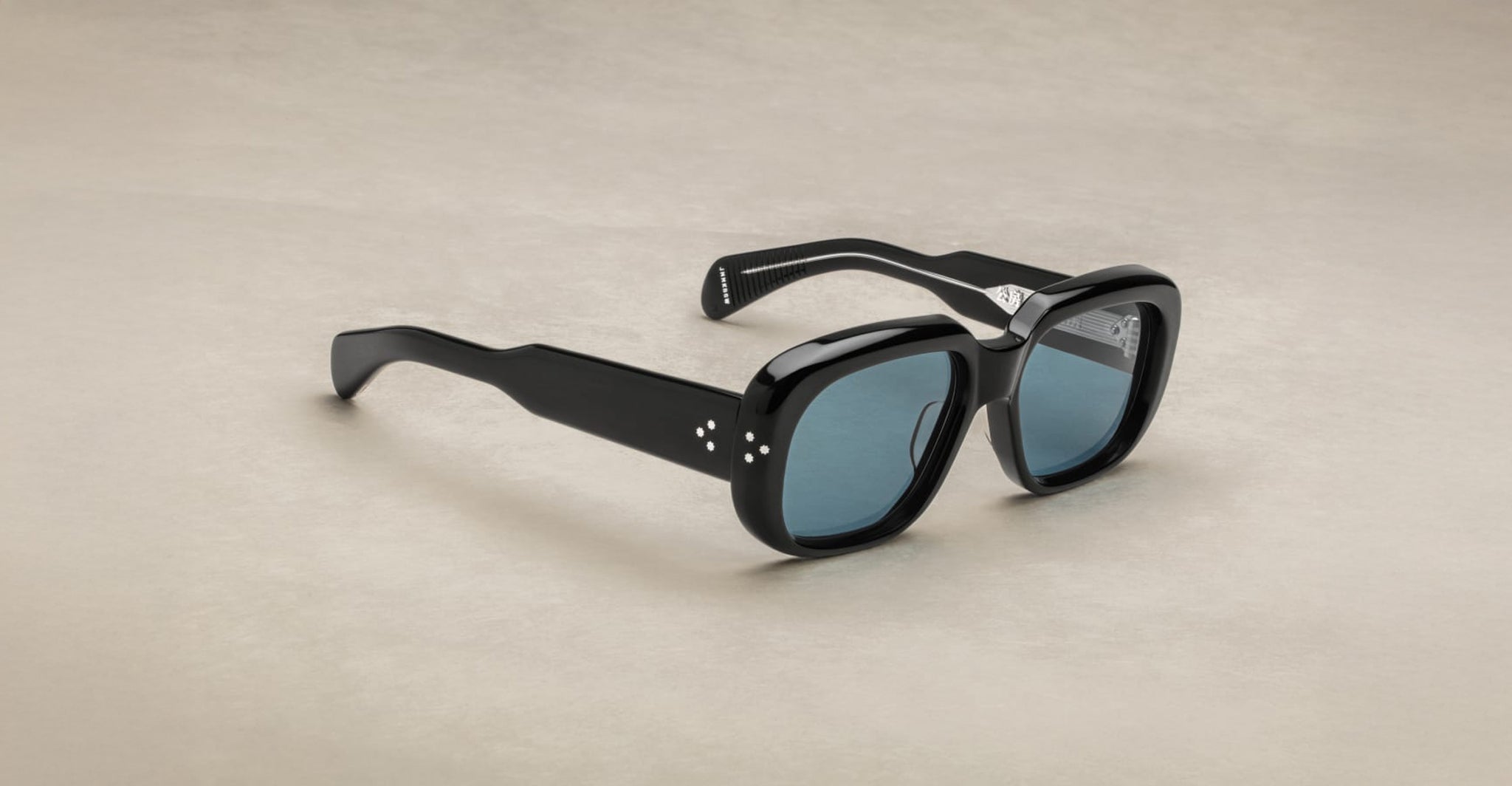 Jacques Marie Mage Kobo sunglasses, black rectangular frames, thick design with blue-tinted lenses, front-facing view.