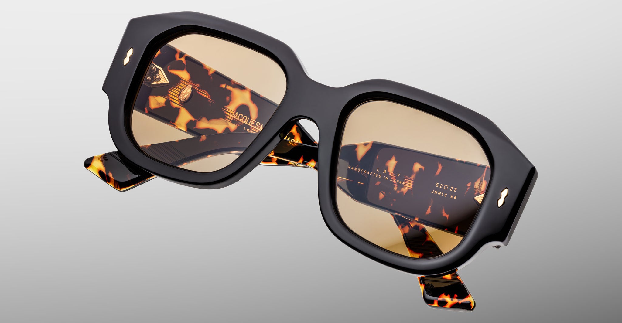 Jacques Marie Mage Lacy sunglasses, chunky square design with black frames, tortoiseshell arms, and UV light brown lenses.
